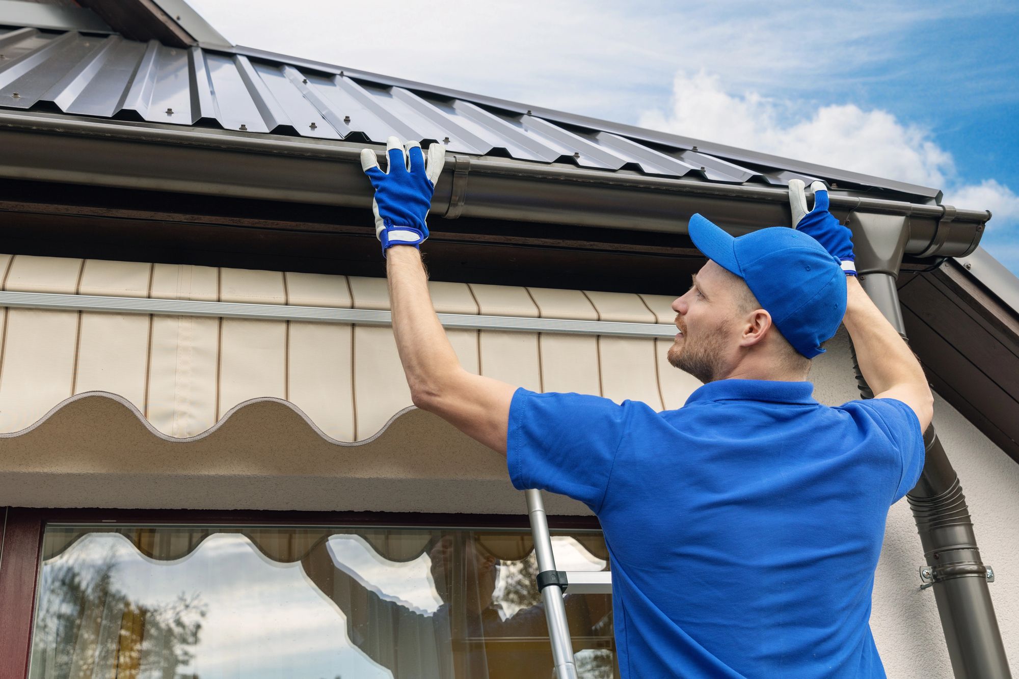 A Seamless crew member installing a gutter
